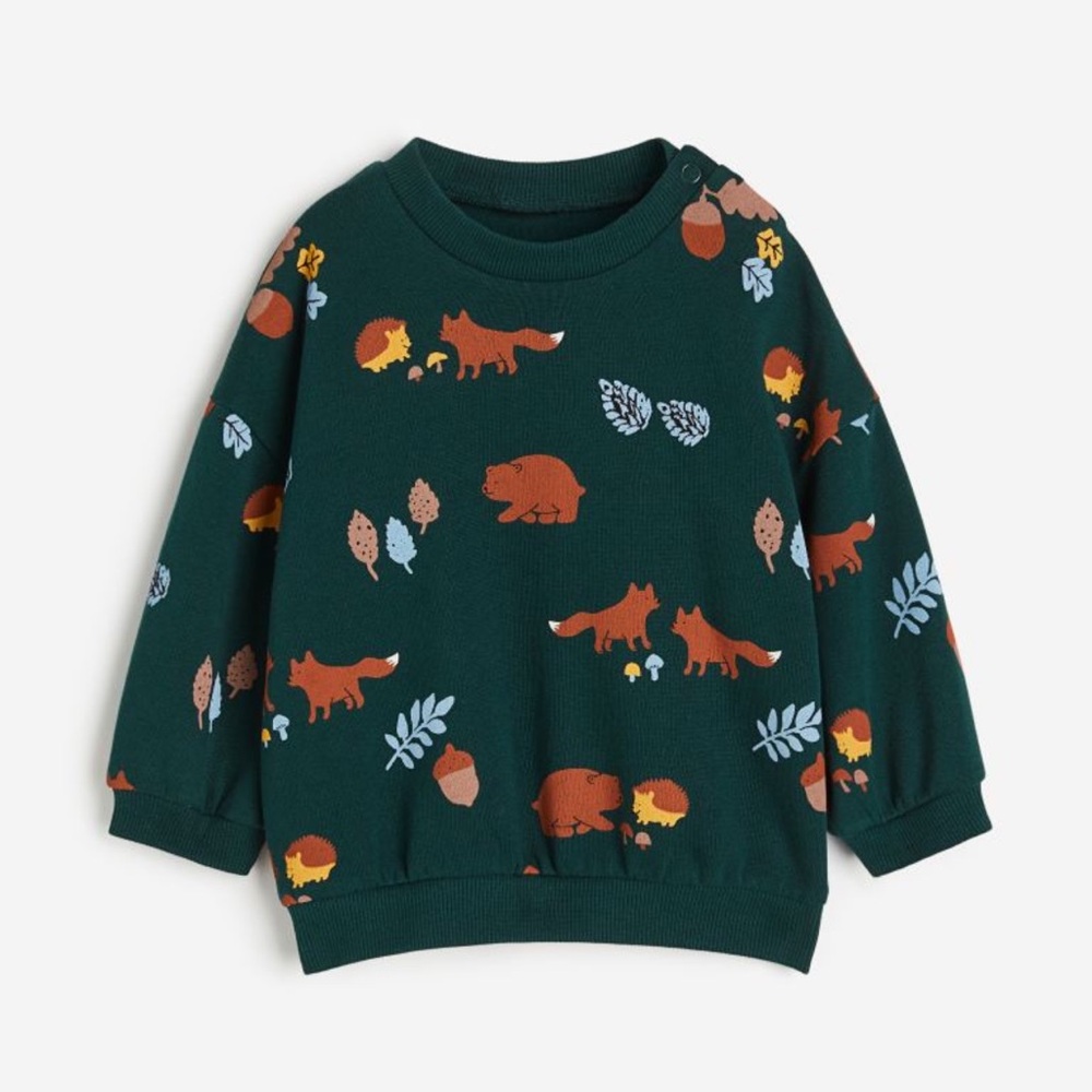 Sweatshirt with fasteners at shoulder